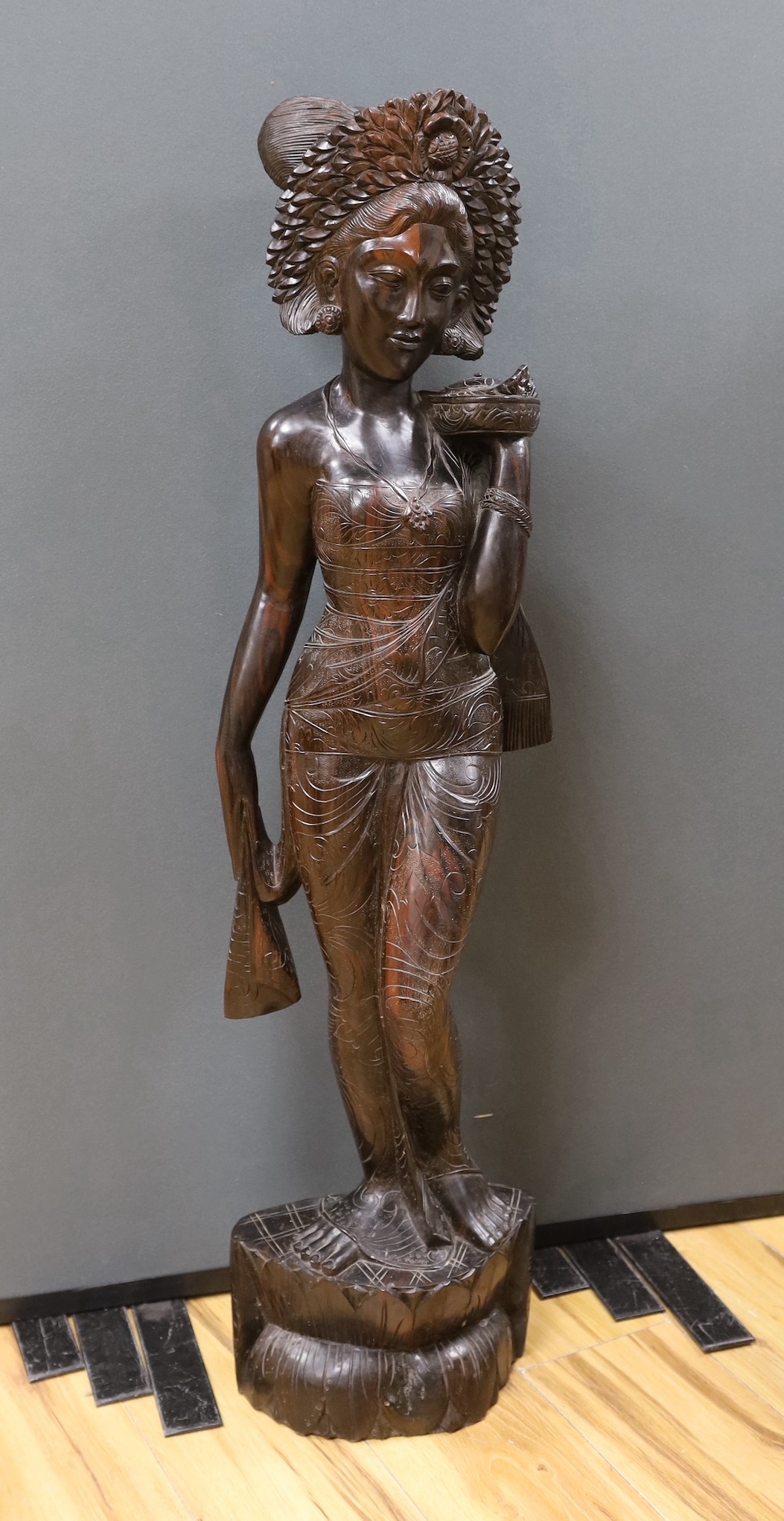 An unusually large and well-carved Balinese ebony figure of a standing young girl, early/mid 20th century. From a Bournemouth estate, 105cm high